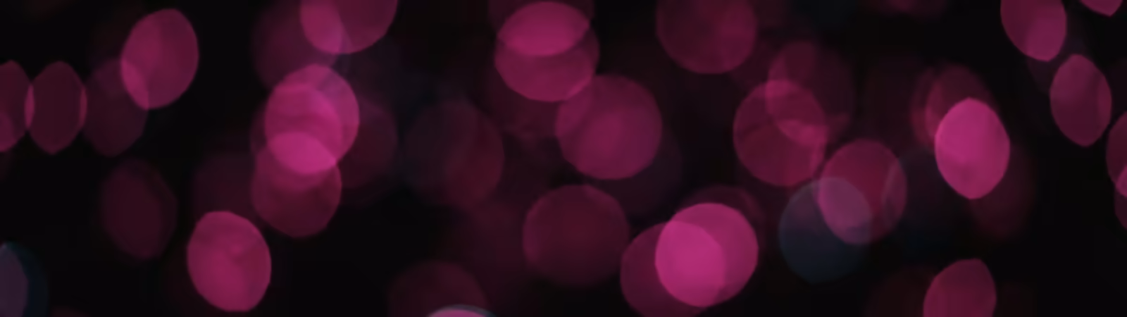Soft magenta bokeh on a black background