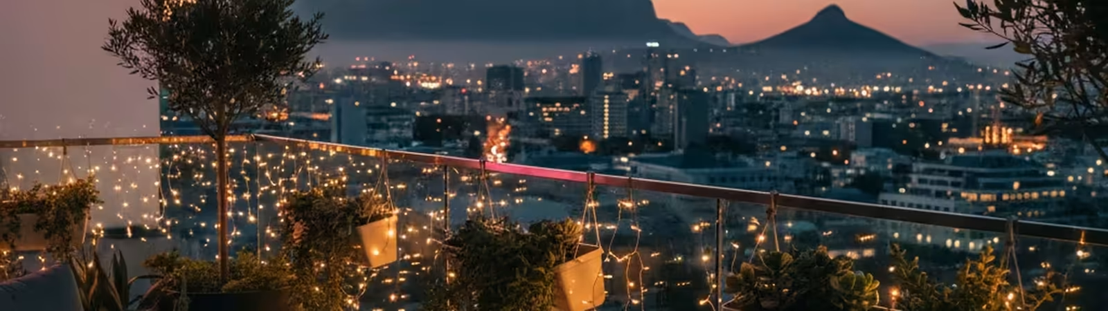 Cape Town apartment balcony at twilight with a laptop