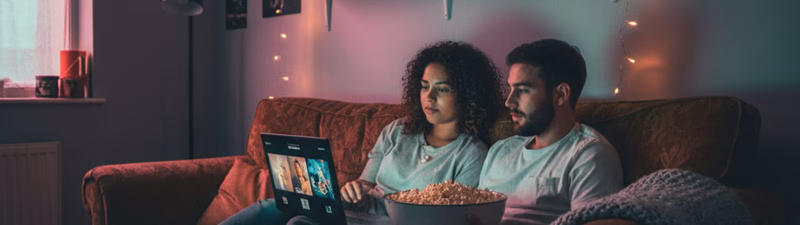 Two students streaming a movie on a laptop