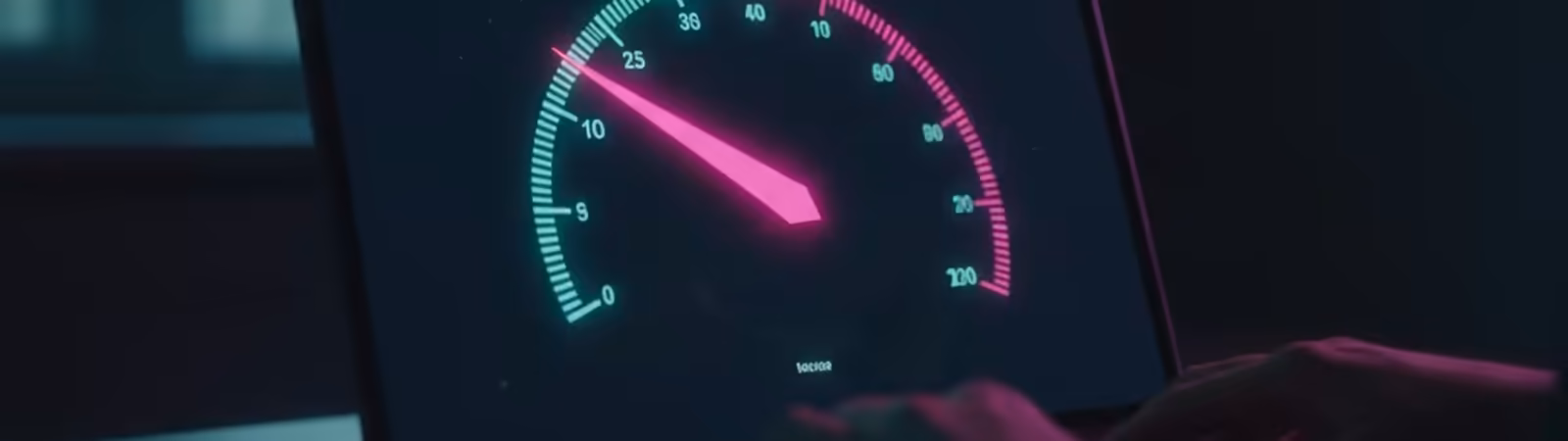 Laptop screen showing a glowing speed test dial
