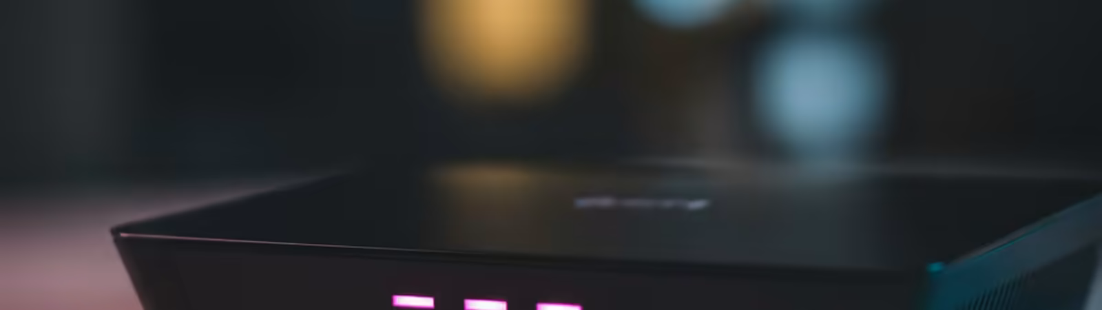 Close-up of a wifi router with glowing magenta LEDs